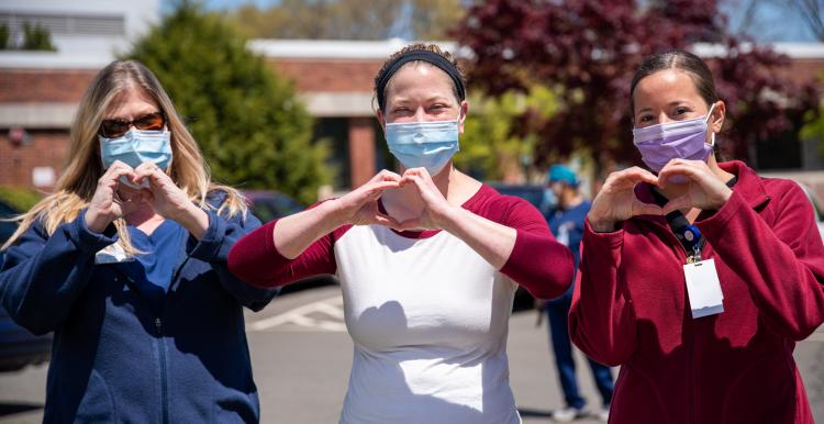 3 care workers. Love sign with hands 3 care workers. Love sign with hands