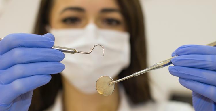 dentist holding an instrument