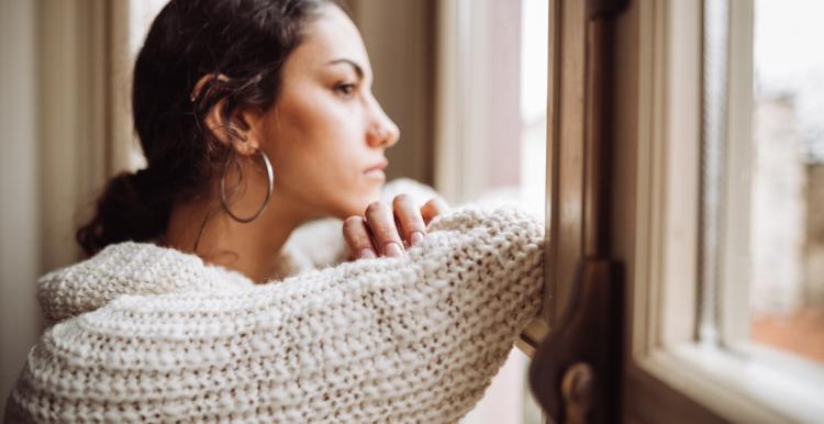 Woman loooking out the window