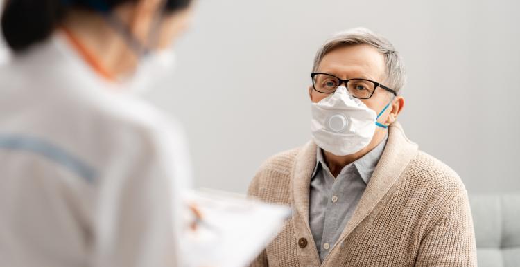 man with facemask at doctors office man with facemask at doctors office