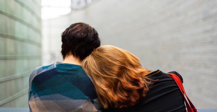 person with head on another's persons shoulder person with head on another's persons shoulder