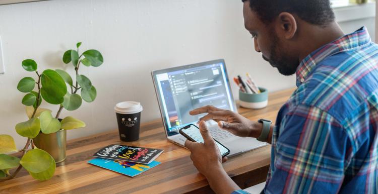 man on phone and computer man on phone and computer