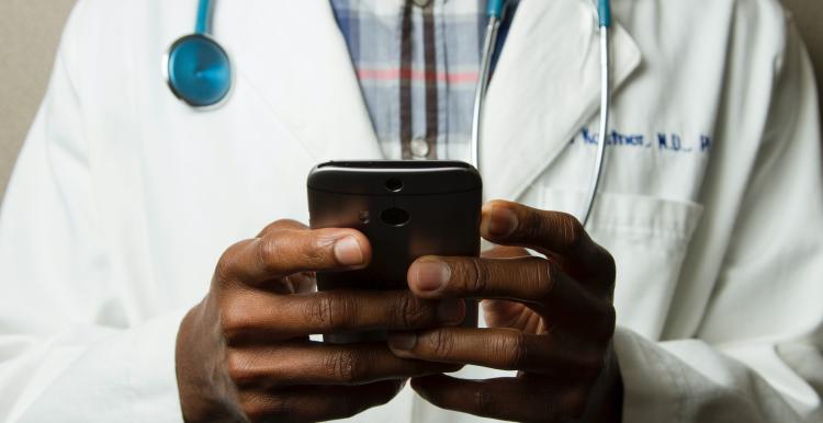 Doctor looking at a mobile phone