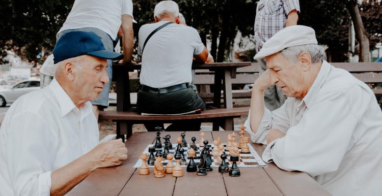 two elderly men playing chess two elderly men playing chess