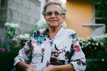 Elderly woman sitting outside