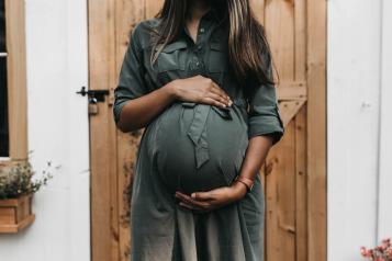 Pregnant woman holding her belly