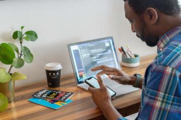 man on phone and computer