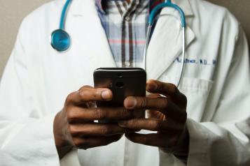 Doctor looking at a mobile phone