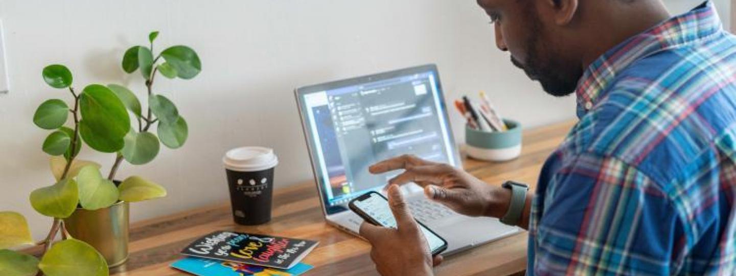 man on phone and computer