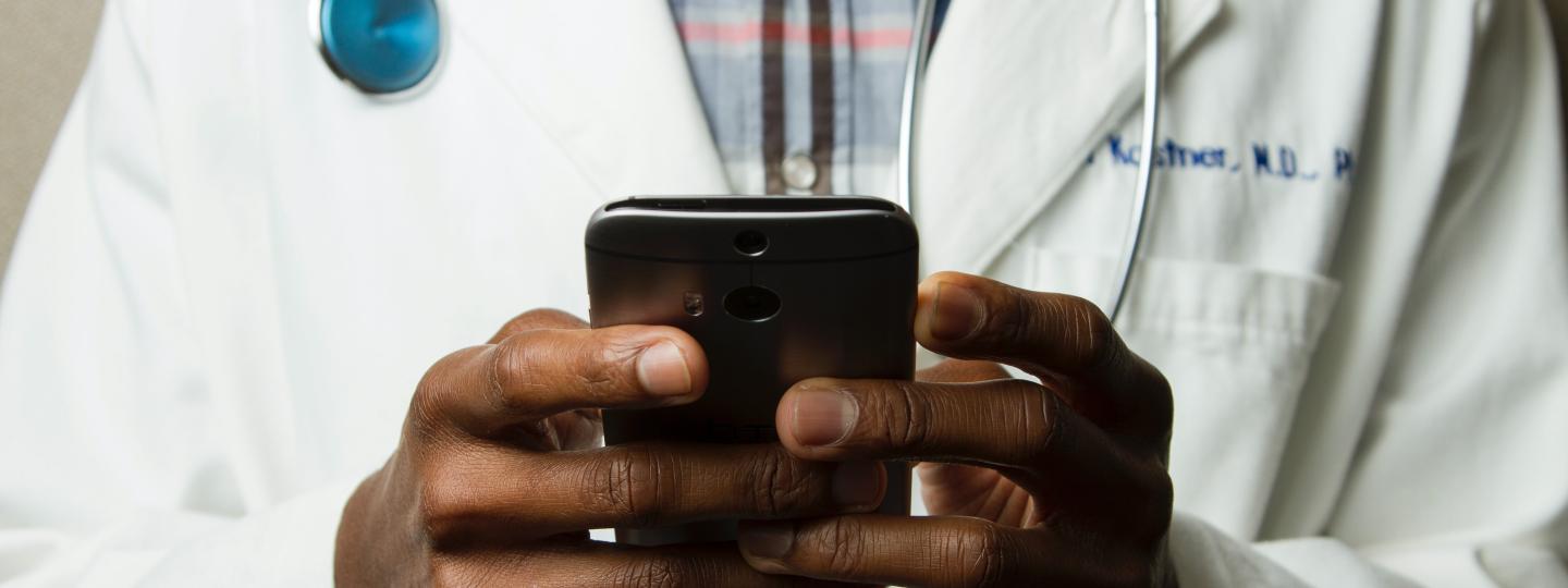 Doctor looking at a mobile phone