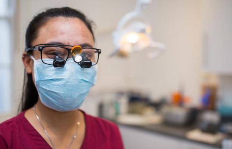 Smiling dentist with mask
